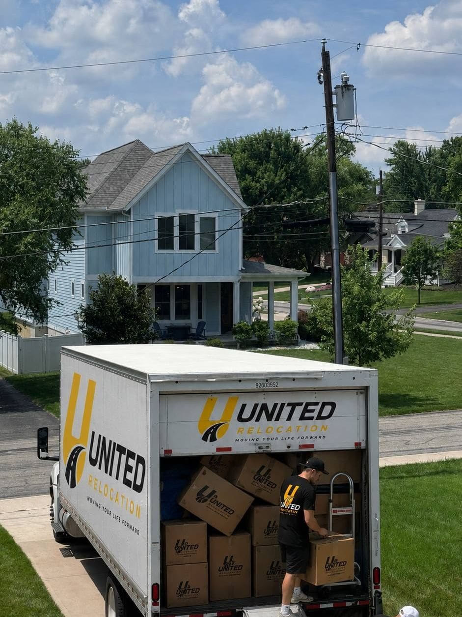 United Relocation truck on a driveway with the crew loading boxes